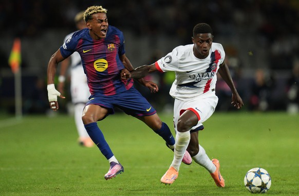 PSG's Nuno Mendes fouls Barcelona's Lamine Yamal during the Champions League opening phase soccer match between Barcelona and Paris Saint-Germain at the Lluis Companys Olympic Stadium in Bar ...