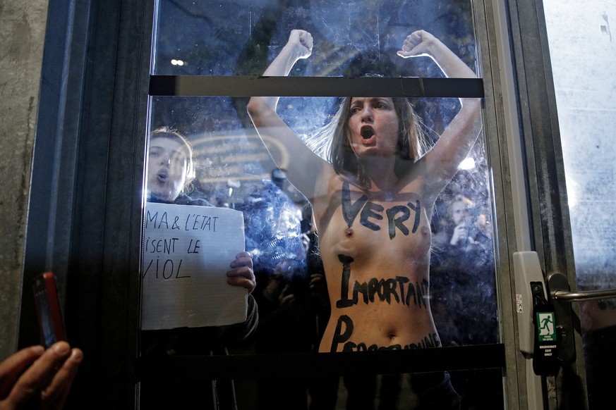 epa06298907 Activists from the feminist group Femen shout slogans against Polish-French director Roman Polanski (not pictured) as he arrives at La Cinematheque for the launch of his retrospective in P ...