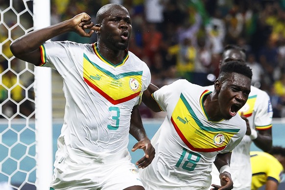 epa10336731 Kalidou Koulibaly (L) of Senegal celebrates with teammate Ismaila Sarr (R) after scoring the 2-1 lead during the FIFA World Cup 2022 group A soccer match between Ecuador and Senegal at Kha ...