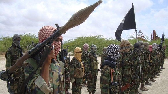 FILE - Al-Shabaab fighters display weapons as they conduct military exercises in northern Mogadishu, Somalia, on Oct. 21, 2010. The United Nations Security Council on Thursday Nov. 9, 2023 suspended f ...