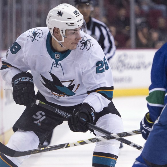 San Jose Sharks right wing Timo Meier (28) and center Chris Tierney (50) try to get past Vancouver Canucks defenseman Michael Del Zotto (4) during first-period NHL hockey game action in Vancouver, Bri ...