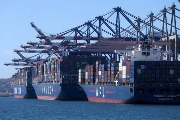 Cargo containers sit stacked on ships at the Port of Los Angeles, Wednesday, Oct. 20, 2021 in San Pedro, Calif. California Gov. Gavin Newsom on Wednesday issued an order that aims to ease bottlenecks  ...