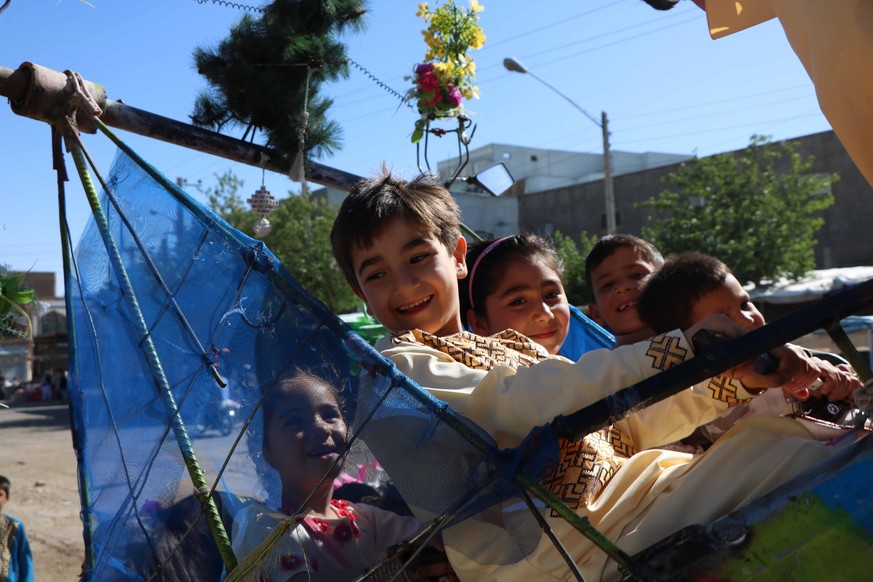 epa06811882 Afghan children celebrate Eid al-Fitr in Jalalabad, Afghanistan, 15 June 2018. Muslims around the world are celebrating Eid al-Fitr, the three day festival marking the end of the Muslim ho ...