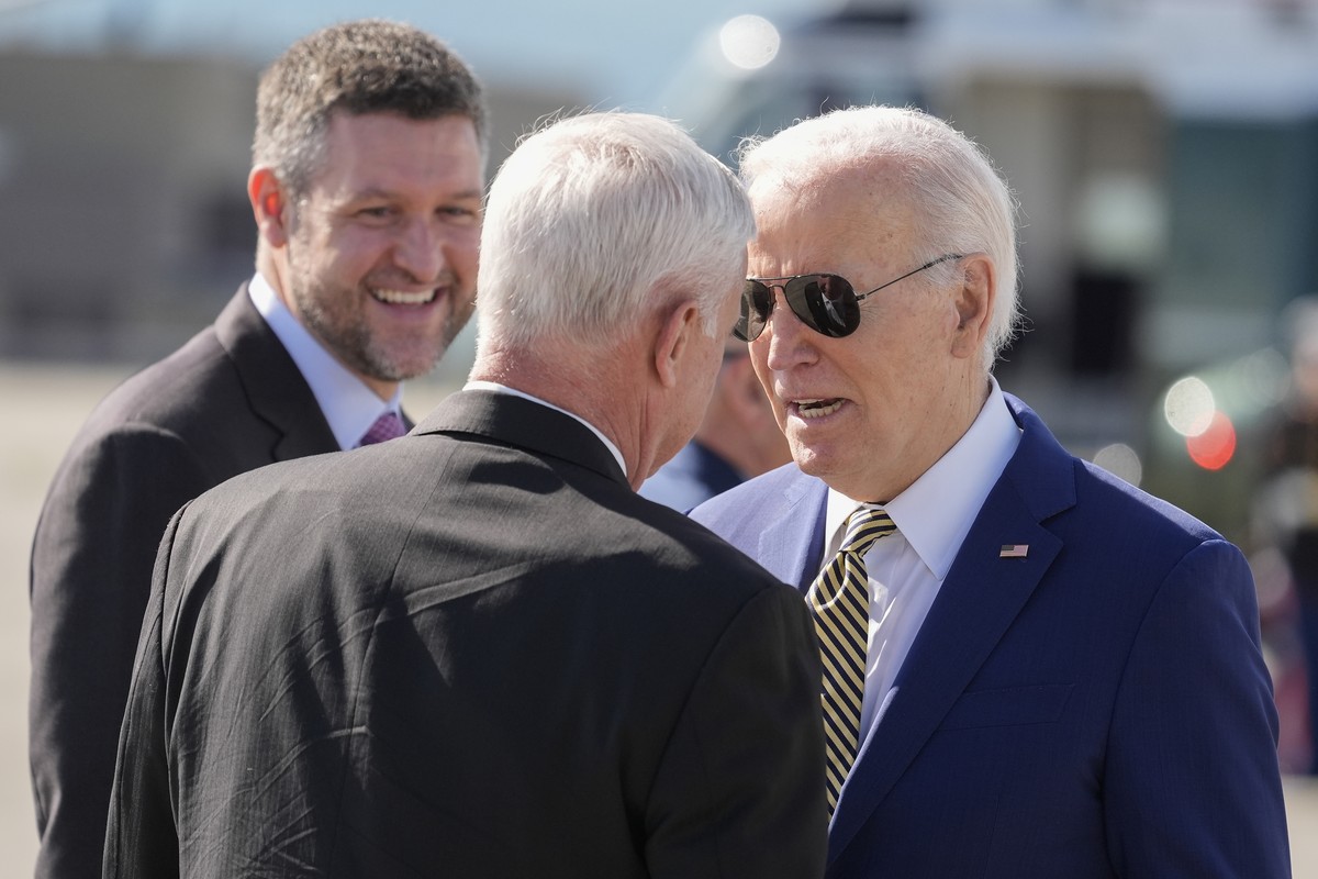 President Joe Biden, right, is greeted by Rep. Steve Womack, R-Ark., center, as Rep. Pat Ryan, D-NY., left, looks on after arriving on Air Force One at Stewart Air National Guard Base in Newburgh, N.Y ...