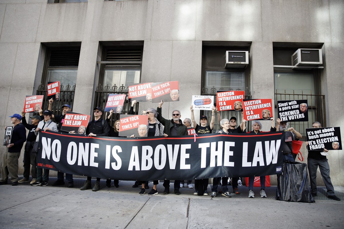 Protestors demonstrate outside Manhattan criminal court on the first day of Donald Trump's criminal trial, Monday, April 15, 2024, in New York. The hush money trial of former President Donald Tru ...