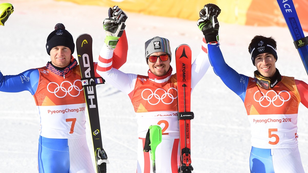 epa06519937 Gold medal winner Marcel Hirscher (C) of Austria is flanked by silver medalist Alexis Pinturault (L) of France and bronze winner Victor Muffat-Jeandet of France after the Men's Alpine ...
