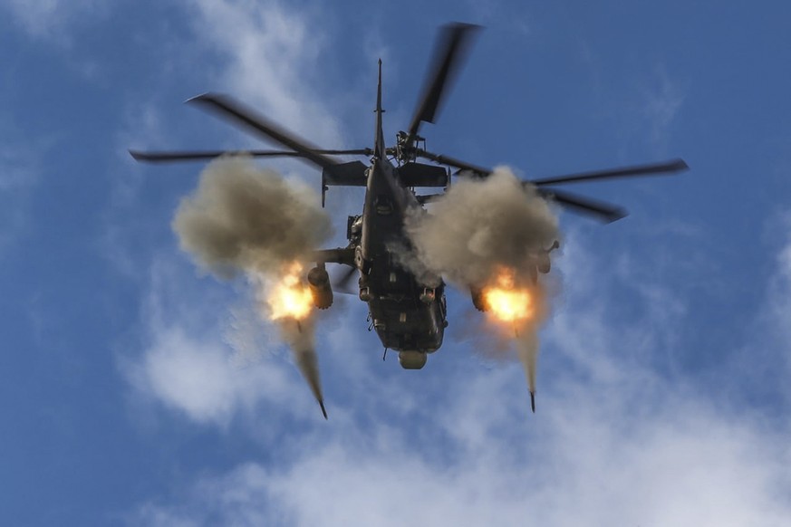 FILE - In this handout photo taken from video and released by Russian Defense Ministry Press Service on Friday, Oct. 28, 2022, a Ka-52 helicopter gunship of the Russian air force fires rockets at a ta ...