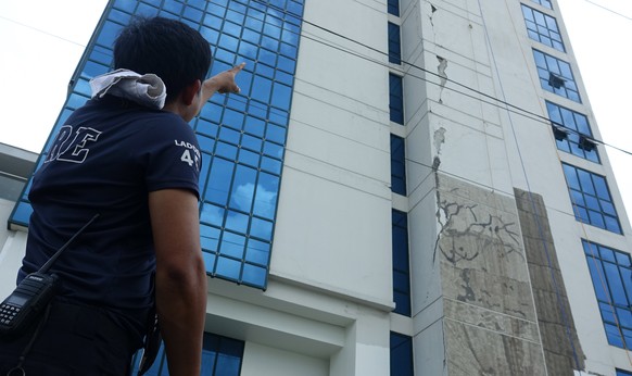 epa07957313 A villager gestures outside a damaged building after earthquake shockwaves hit, in Davao City, Philippines, 29 October 2019. According to the Philippine Institute of Volcanology and Seismo ...