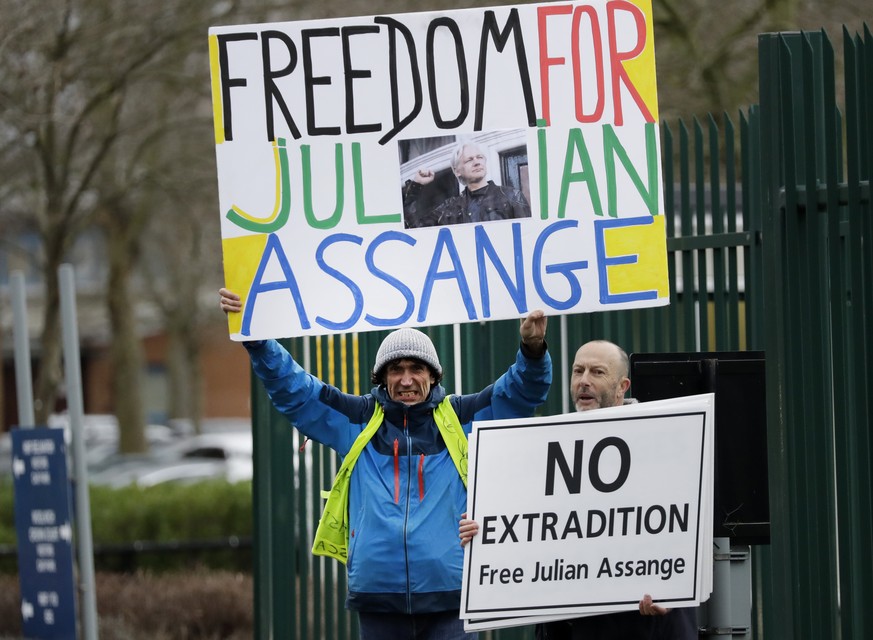 Supporters hold signs which read &#039;Freedom for Julian Assange&#039; and &#039;No extradition, free Julian Assange&#039; as they protest against the extradition of Wikileaks founder Julian Assange  ...