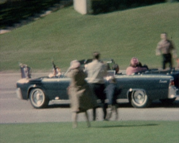 First Lady Jacqueline Kennedy cradles her husband President John F. Kennedy seconds after he was fatally shot. This frame grab image was made from a restored version of a film showing the assassinatio ...