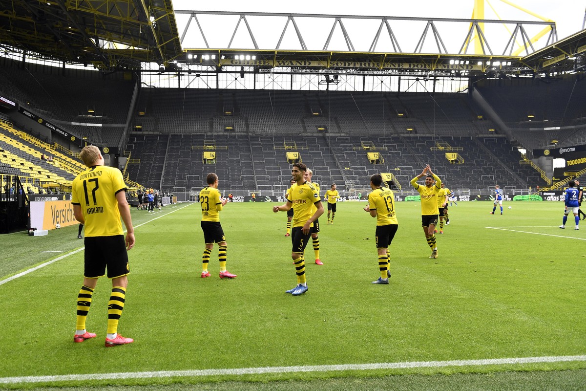 Dortmund's Erling Haaland, left, celebrates after scoring the opening goal during the German Bundesliga soccer match between Borussia Dortmund and Schalke 04 in Dortmund, Germany, Saturday, May 1 ...