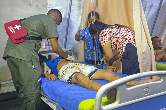 Yorvis Hernandez, a 34-year-old miner, gets medical attention at at tent set up next to a mine after it collapsed in La Paragua, Bolivar state, Venezuela, Wednesday, Feb 21, 2024. (AP Photo/Andrea Cal ...
