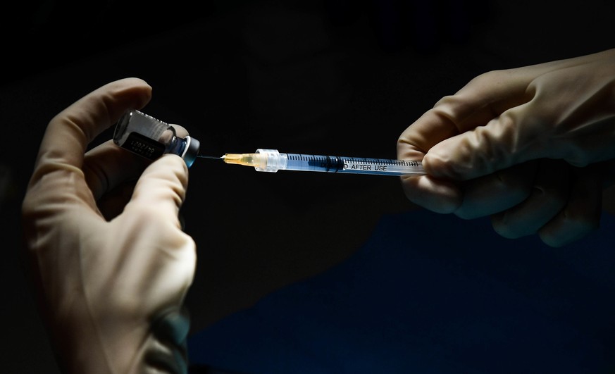 epa08920594 A healthcare worker prepares a syringe with a dose of the Pfizer-BioNTech vaccine at the Villa Scassi Hospital in Genoa, Italy, 05 January 2021. A second batch of 470,000 doses of the Pfiz ...