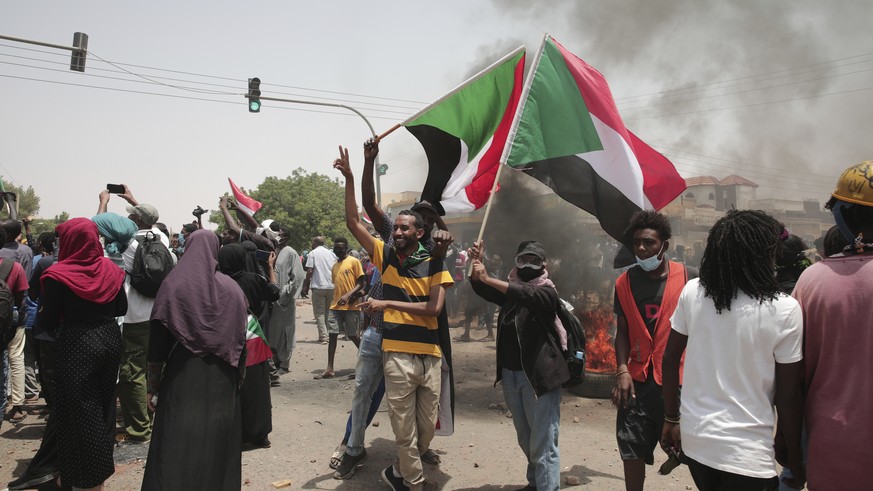Sudanese anti-military protesters march in demonstrations in the capital of Sudan, Khartoum, on Thursday, June 30, 2022. A Sudanese medical group says at least seven people were killed on Thursday in  ...