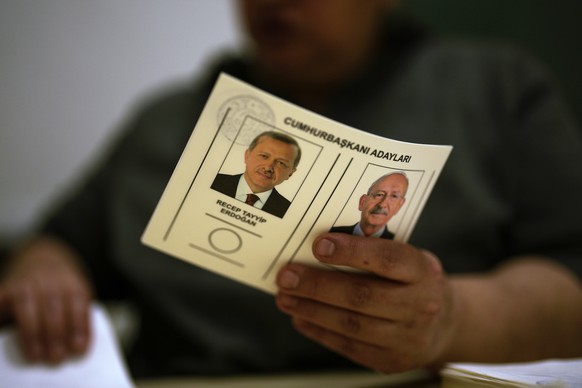 An election representative holds a ballot with presidential candidates at a polling station in Istanbul, Turkey, Sunday, May 28, 2023. Voters in Turkey return to the polls Sunday to decide whether the ...
