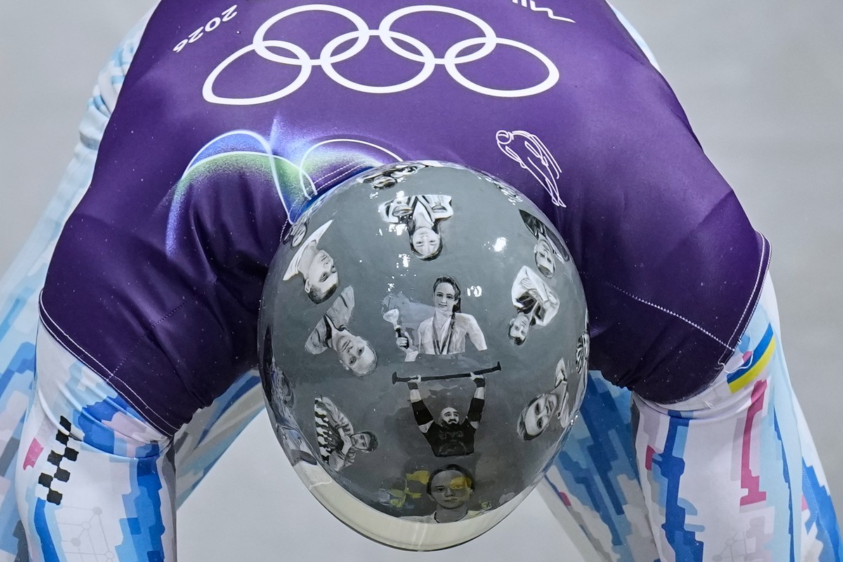 KEYPIX - Ukraine's Vladyslav Heraskevych arrives at the finish during a men's skeleton training session at the 2026 Winter Olympics, in Cortina d'Ampezzo, Italy, Tuesday, Feb. 10, 2026. ...