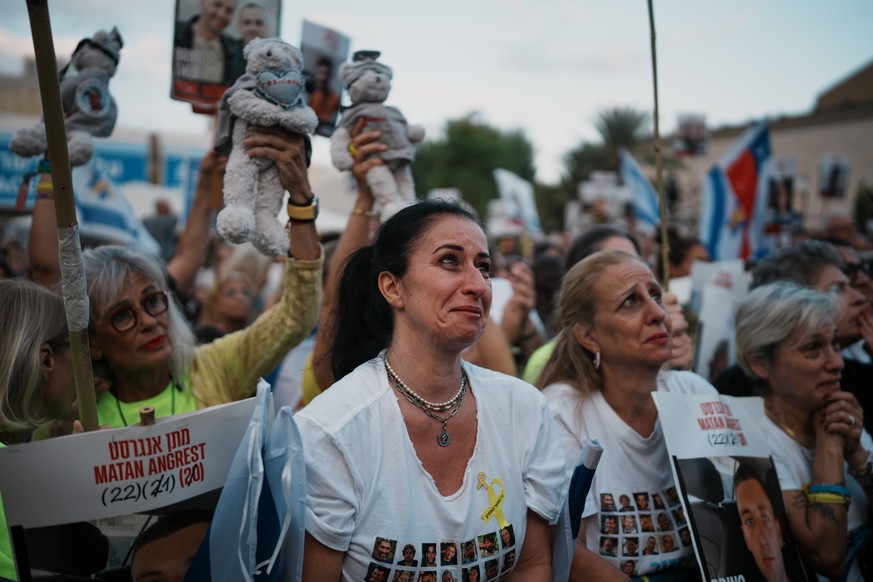 People gather at a plaza known as the hostages square in Tel Aviv, Israel, Monday, Oct. 13, 2025 prior to the release of Israeli hostages held in Gaza. (AP Photo/Emilio Morenatti)
Israel Palestinians  ...