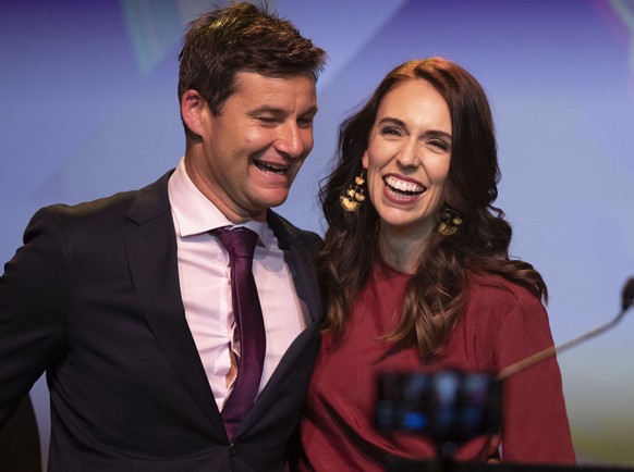 FILE - In this Oct. 17, 2020, file photo, New Zealand Prime Minister Jacinda Ardern, right, is congratulated by her partner Clarke Gayford following her victory speech to Labour Party members at an ev ...