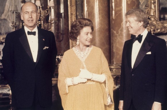 FILE - In this file photo dated May 1977, U.S. President Jimmy Carter, right, and Britain's Queen Elizabeth II with French President Valery Giscard d'Estaing, at Buckingham Palace in London. US Presid ...