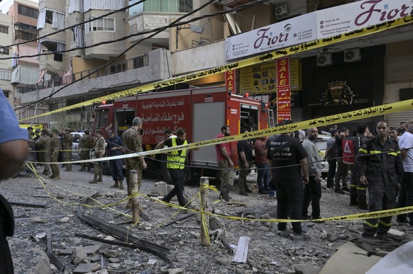 epa12544386 Soldiers and rescuers stand at the site after an Israeli airstrike on the southern suburbs of Beirut, Lebanon, 23 November 2025. The Israeli army announced that it had conducted a precise  ...