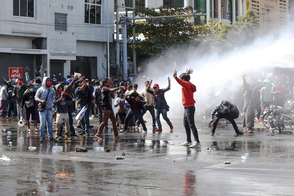 Police use water cannon to disperse demonstrators during a protest in Mandalay, Myanmar, Tuesday, Feb. 9, 2021. Police were cracking down on the demonstrators against Myanmar