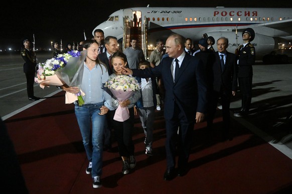 epa11517272 Russian President Vladimir Putin (R) meets Russian citizens released after the Russian-US prisoner swap in Turkiye at Vnukovo International Airport in Moscow, Russia, 01 August 2024. On Au ...