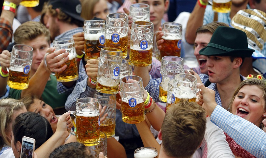 FILE - In this Sept. 19, 2015 file photo, people celebrate the opening of the 182nd Oktoberfest beer festival in Munich, southern Germany. Bavarian state governor Markus Soeder and Munich mayor Dieter ...