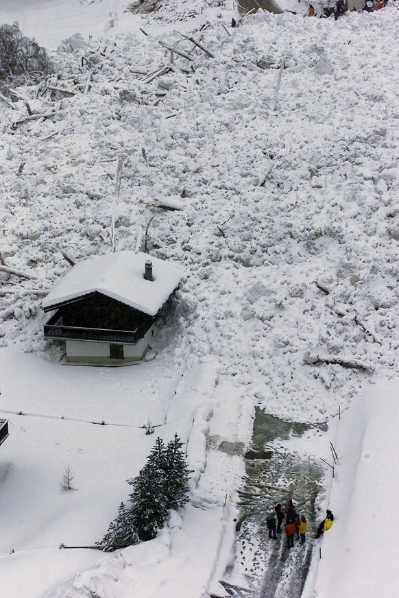 An aerial view shows rescue workers waiting for digging at the fatal of two avalanches which hit the Swiss ski resort of Evolene in the southern Alps Monday Feb. 22, 1999. Two people were killed and s ...