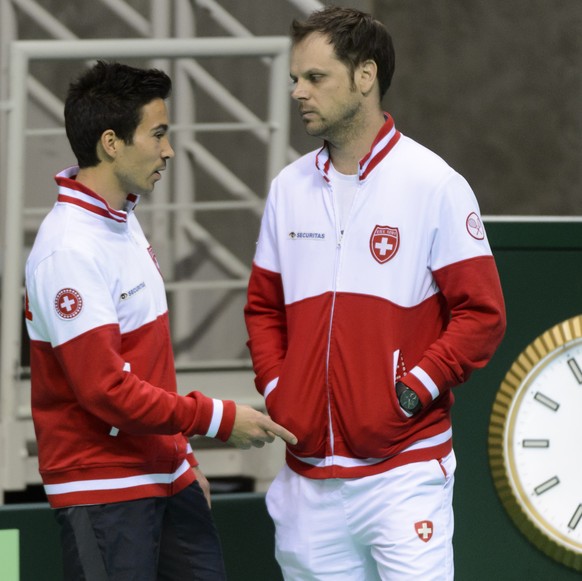 Swiss tennis player Yann Marti, left, speaks with Swiss Davis Cup Team captain Severin Luethi, right, during a training session on the eve of the Davis Cup World Group - First Round, 1/8 final tennis  ...