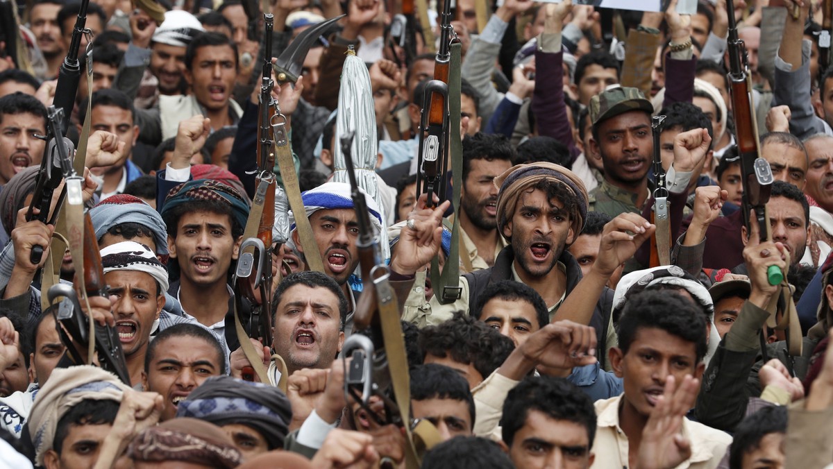 epa10544394 Houthi supporters shout slogans during a protest marking the eighth anniversary of the Saudi-led military campaign on Yemen, in Sana'a, Yemen, 26 March 2023. Thousands of Houthi suppo ...