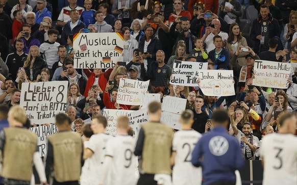 epa10001134 Supporters of Germany hold signs after the UEFA Nations League soccer match between Germany and England in Munich, Germany, 07 June 2022.  EPA/Ronald Wittek