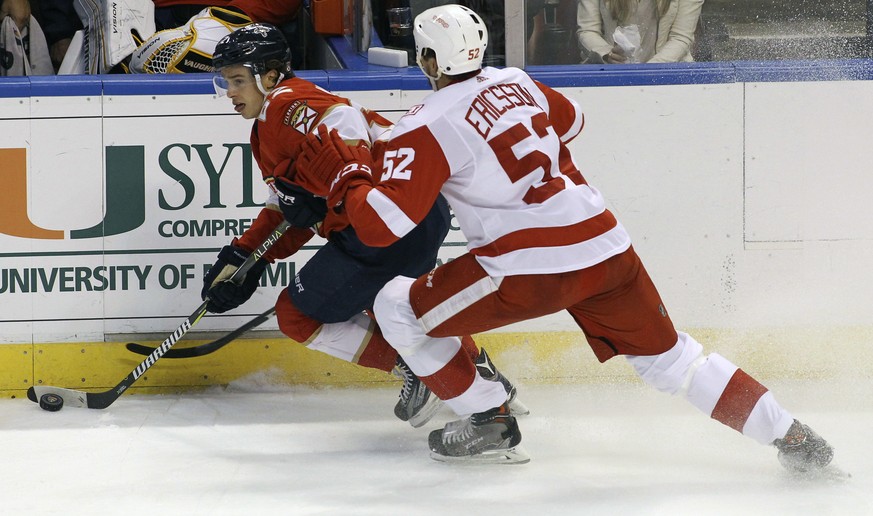 Florida Panthers&#039; Denis Malgin, left, of Switzerland, moves the puck past Detroit Red Wings&#039; Jonathan Ericsson (52), of Sweden, during the second period of an NHL hockey game, Saturday, Oct. ...