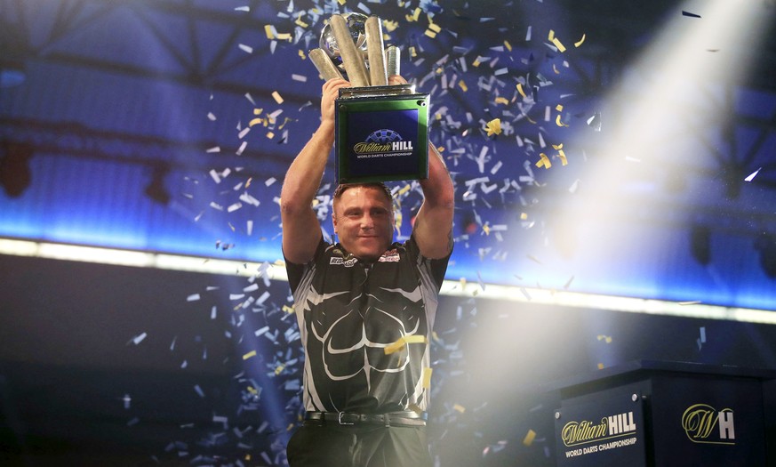Gerwyn Price lifts the trophy after winning the William Hill World Darts Championship at Alexandra Palace, London on Sunday, Jan. 3, 2021. (Adam Davy/PA via AP)