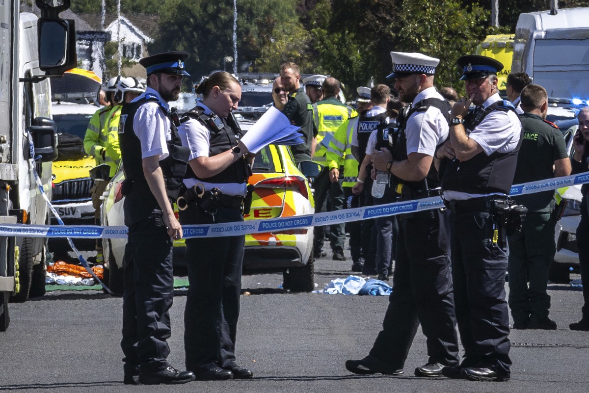 Police secure the area, where a man has been detained and a knife has been seized after a number of people were injured in a reported stabbing, in Southport, Merseyside, England, Monday July 29, 2024. ...