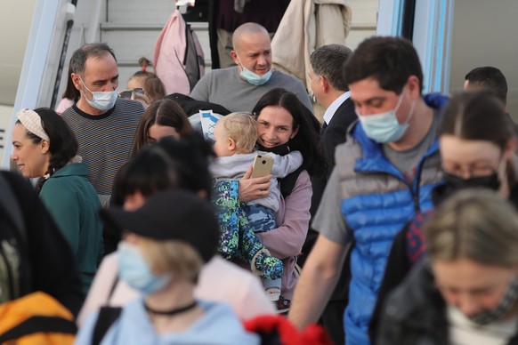 epa09805780 Ukrainian Jews disembark a plane arriving at Ben Gurion international airport near Tel Aviv, Israel, 06 March 2022. Three flights carrying around 300 Ukrainian Jews arrived from Poland and ...