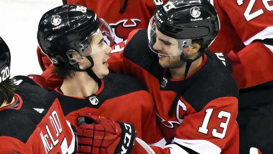 New Jersey Devils&#039; Jack Hughes celebrates with Nico Hischier (13) after Hughes scored the winning goal during the overtime period of an NHL hockey game against the Edmonton Oilers, Friday, Dec. 3 ...