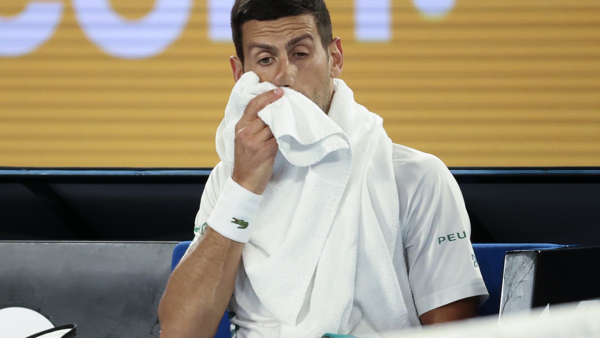 Serbia's Novak Djokovic wipes his face during a break in his fourth round match against Canada's Milos Raonic at the Australian Open tennis championship in Melbourne, Australia, Sunday, Feb. ...
