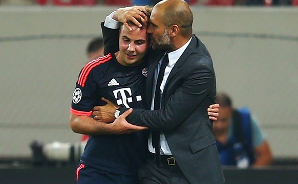 PIRAEUS, GREECE - SEPTEMBER 16: Head coach Pep Guardiola of Muenchen hugs Mario Goetze after the UEFA Champions League Group F match between Olympiacos FC and FC Bayern Muenchen at Karaiskakis Stadium ...
