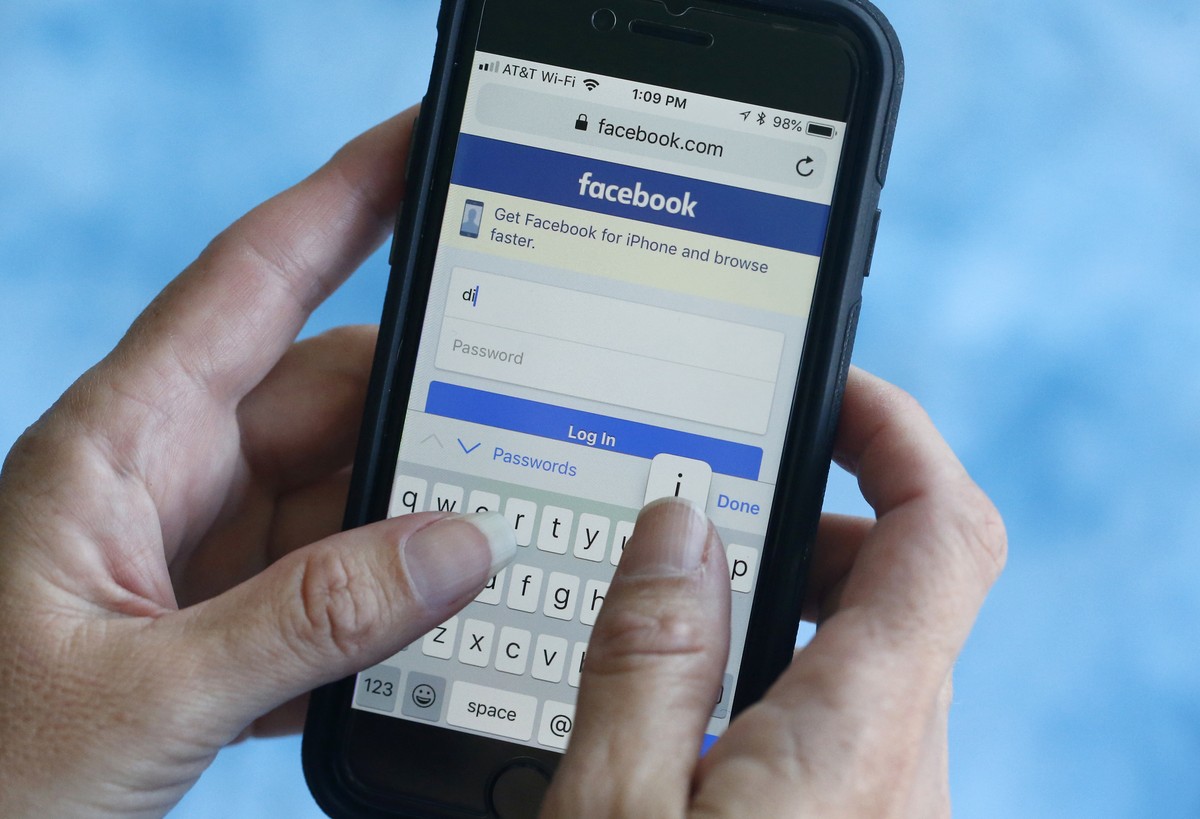 FILE - In this file photo dated Tuesday, Aug. 21, 2018, a Facebook start page is shown on a smartphone in Surfside, Fla. USA. The social media giant Facebook said Thursday Aug. 23, 2018, it has banned ...