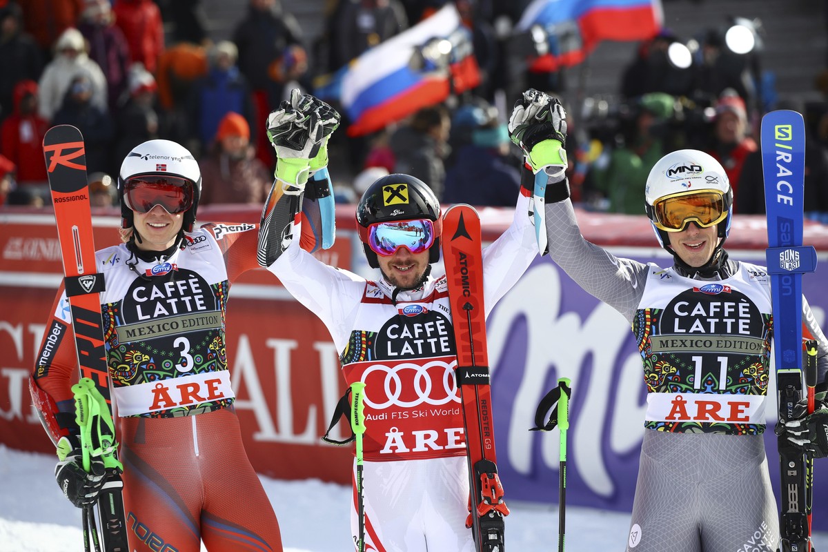 Austria's Marcel Hirscher, center, the winner, poses with runner-up Norway's Henrik Kristoffersen, and third placed France's Victor Muffat-Jeandet in the finish area after completing a  ...