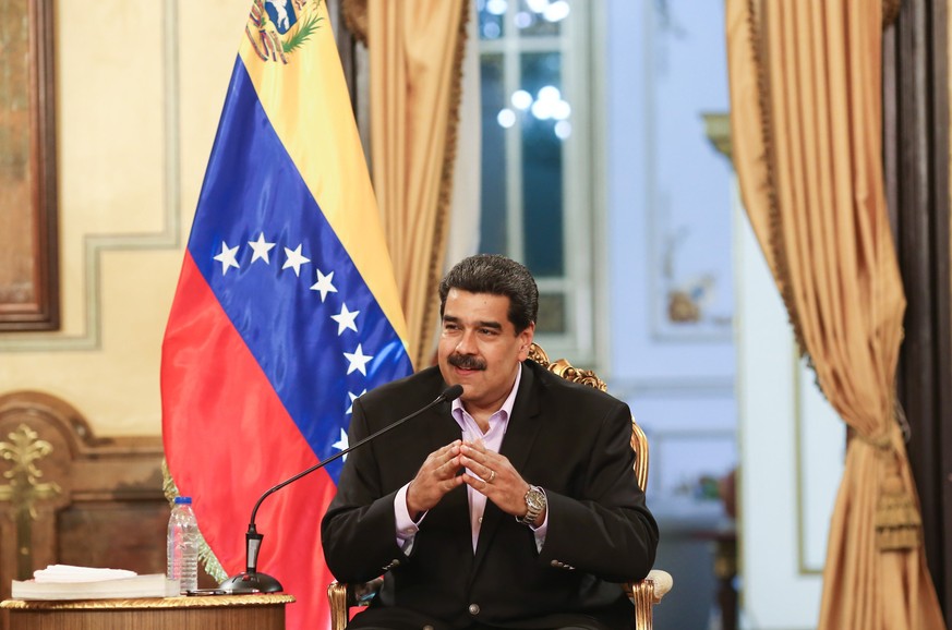 epa07328634 A handout photo made available by Miraflores Press shows President of Venezuela Nicolas Maduro participating in a government act, where he receives Venezuelan diplomatic officials from the ...