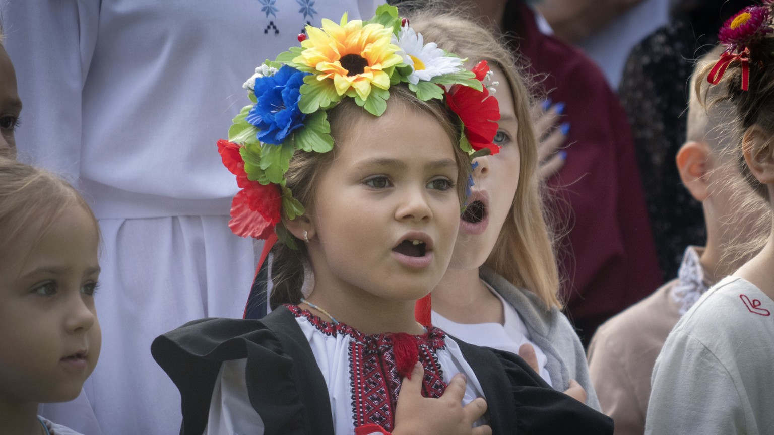 School children sing Ukraine&#039;s national anthem as they attend a ceremony of the first day in school in Bucha, Ukraine, Friday, Sept. 1, 2023. Ukraine marks Sept. 1 as Knowledge Day, as a traditio ...