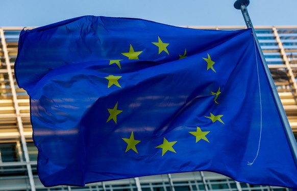 epa08999148 A European flag is seen in front of the European Commission in Brussels, Belgium, 09 February 2021. EPA/STEPHANIE LECOCQ