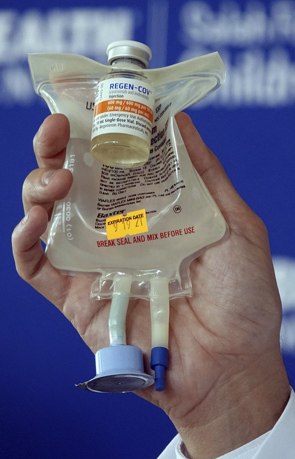 Dr. Aldo Calvo, Medical Director of Family Medicine at Broward Health, shows a Regeneron monoclonal antibody infusion bag during a news conference, Aug. 19, 2021 at the Hospital in Fort Lauderdale, Fl ...
