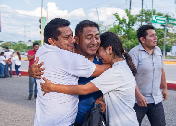 epa10720110 Relatives greet some of the 16 Ministry of Public Security employees abducted by an armed group in the southern Mexican state of Chiapas on June 27;  after they were found alive in the...