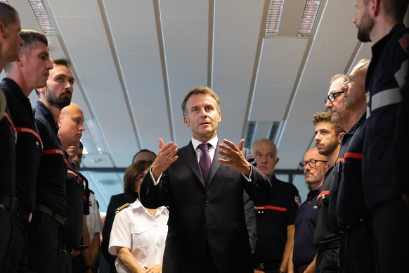 France's President Emmanuel Macron thanks personnel engaged in firefighting efforts during a visit to the Departmental Fire and Rescue Operational Center (CODIS) in Bordeaux, following wildfires  ...