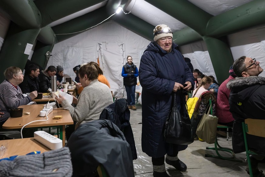Anwohner in Kiew halten sich in beheizten Notfallzelten des Katastrophenschutzes auf, die Schutz, Strom und warme Getränke während der anhaltenden russischen Angriffe bieten.