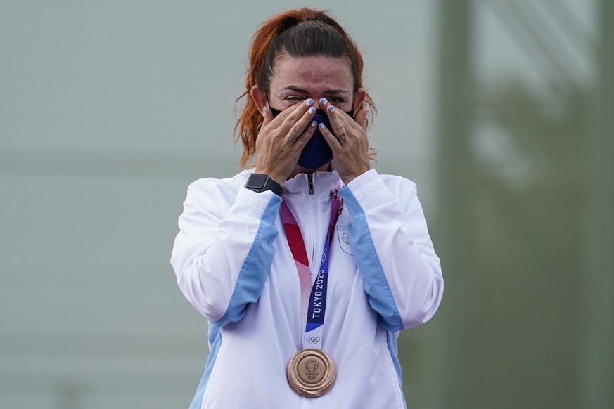 Bronze medalist Alessandra Perilli, of San Marino, wipes he eyes as she celebrates after the women&#039;s trap at the Asaka Shooting Range in the 2020 Summer Olympics, Thursday, July 29, 2021, in Toky ...