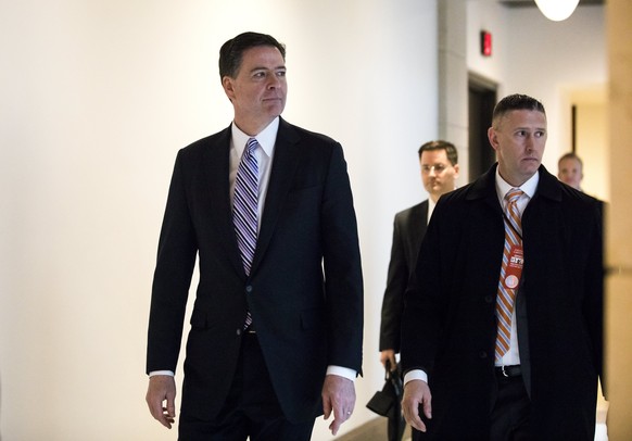 epa05850855 FBI Director James Comey (L) departs a meeting with members of Congress at the US Capitol in Washington, DC, USA, 15 March 2017. Lawmakers have said they have seen no evidence to back US P ...