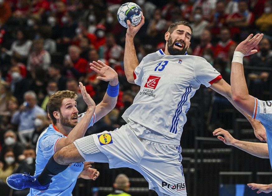 Nikola Karabatic, right, of France in action against Jasper Adams, left, of Netherlands during the Men&#039;s European Handball Championship main round Group I match between France and Netherlands at  ...